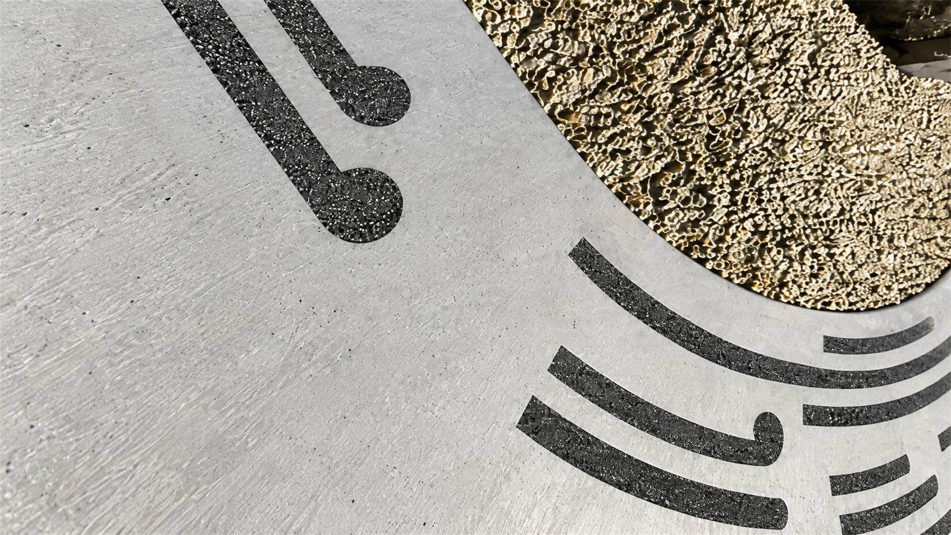 Close-up of a fabricated stone-and-steel surface with dark inlaid grit lines
