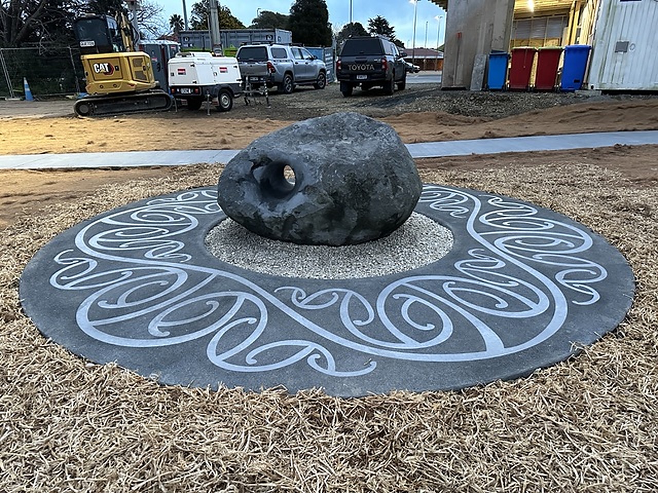 The hollowed stone centred on its swirl-engraved concrete disc, reserve behind
