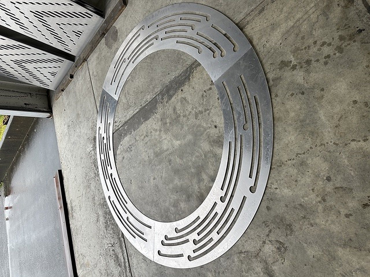 Detail of a radial-cut steel ground ring set into concrete